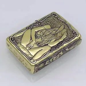 KZ157-01 Gold-toned lighter with an Art Nouveau engraving of a reclining woman holding a hat, surrounded by ornate borders and lattice background.