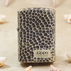 Zippo lighter with a black and beige snakeskin texture standing upright on a neutral surface.