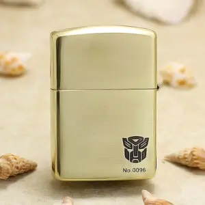 Gold metal lighter with brushed finish, showing the Transformers Autobot logo and No.0096.