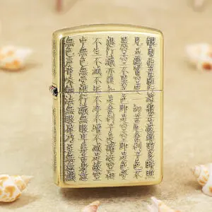 Gold Zippo lighter with vertical lines of Chinese characters engraved along its front surface.