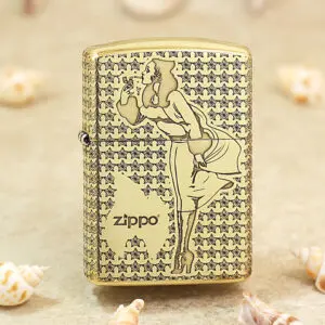 Gold-tone Zippo lighter with a stylized woman smoking motif set against a star-patterned background