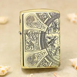 Gold Zippo lighter with intricate Celtic knotwork and floral engravings on its surface.