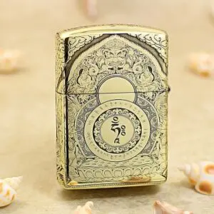 KZ304-01 Ornate gold lighter with intricate engravings and a central circular motif, standing on a beige surface.