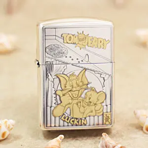 Metal Zippo lighter with a Tom and Jerry cartoon on the front, showing Tom and Jerry posing together with the 'Tom and Jerry' label at the top and 'LUCKIN' text at the bottom.