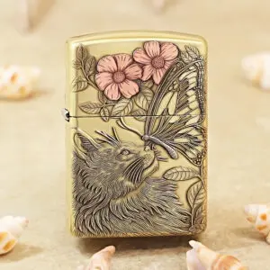 Beige metal lighter with a detailed engraving of a wolf, butterfly, and pink flowers among leaves.