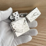 Open Guanyin sterling silver Zippo Armor lighter showing lotus reverse artwork