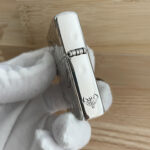 Hinge and flame detail on the Guanyin sterling silver Zippo Armor lighter