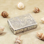 Horizontal view of the Brave Troops sterling silver Zippo lighter showing lid and edge engraving