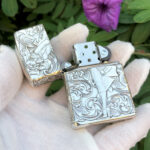 Open front view showing the Varga Girl pin-up and arabesque engraving on the sterling silver Zippo Armor lighter