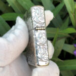 Opposite side engraving on the Varga Girl arabesque sterling silver Zippo Armor lighter