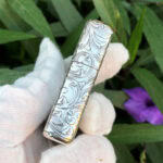 Opposite narrow-side arabesque engraving on the Varga Girl sterling silver Zippo Armor lighter