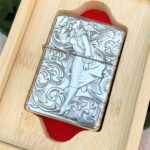 Angled display-box view of the Varga Girl five-side engraved sterling silver Zippo Armor lighter