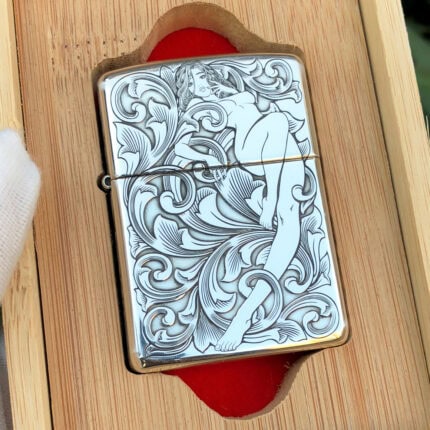 Front view of the reclining woman and arabesque five-side engraved sterling silver Zippo Armor lighter