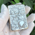 Reverse view with female portrait and arabesque decoration on the sterling silver Zippo Armor lighter