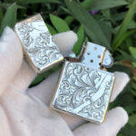 Open front view showing the reclining woman engraving and Zippo insert