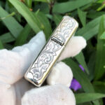 Hinge-side close-up of the arabesque woman sterling silver Zippo Armor lighter