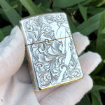 Angled front view showing deep arabesque relief on the sterling silver Zippo Armor lighter
