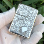 Angled reverse view with female portrait and scroll engraving on the sterling silver Zippo Armor lighter