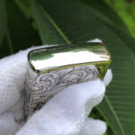 Polished top edge of the dragon and phoenix sterling silver Zippo Armor lighter