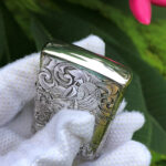Angled top view showing polished edge and wraparound dragon engraving