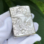 Straight reverse view of the phoenix and arabesque design on the sterling silver Zippo Armor lighter