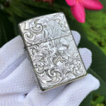 Angled front view of the dragon and phoenix sterling silver Zippo Armor lighter