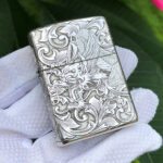 Centered front view of the five-side dragon and phoenix sterling silver Zippo Armor lighter