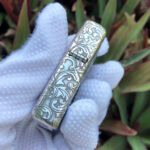 Arabesque scroll engraving along the side of the sterling silver Zippo Armor lighter