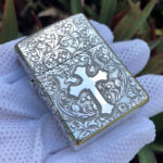 Raised cross panel and floral scrollwork on the sterling silver Armor lighter
