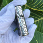 Hinge-side arabesque engraving on the sterling silver Zippo Armor case