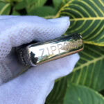 Polished top edge with Zippo logo on the Arabesque Cross sterling silver case
