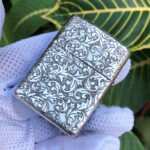 Full reverse arabesque pattern on the sterling silver Zippo Armor lighter