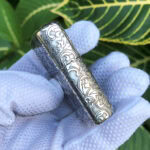 Ornamental side scrollwork on the Arabesque Cross sterling silver lighter