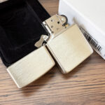 Zippo #13 sterling silver lighter open beside its presentation box
