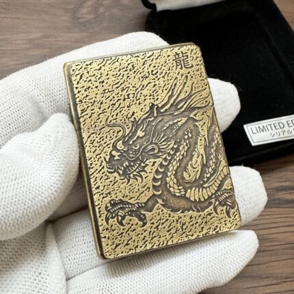 Zippo brass-tone dragon lighter with textured engraving and dragon character on the front