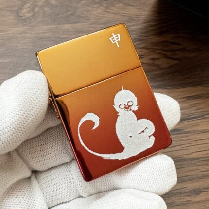 Front of iridescent Zippo 1935 Replica with silver-tone monkey artwork and zodiac character