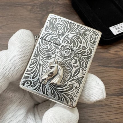Zippo 1935 Replica horse lighter with raised horse-head emblem and engraved scrollwork