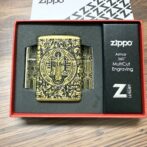 Brass Zippo lighter with ornate circular engraving in a red gift box.