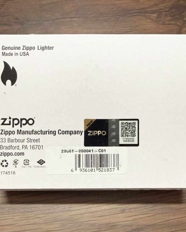 White Zippo lighter box on a wooden surface, showing the Genuine Zippo Lighter label and barcode.