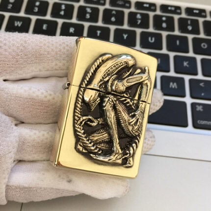 H.R. Giger Alien Anniversary high-polish brass Zippo lighter front view