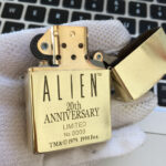 Open H.R. Giger Alien Anniversary brass Zippo lighter front view