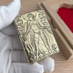 Asura high-polish brass Zippo Armor deep-carved lighter front view