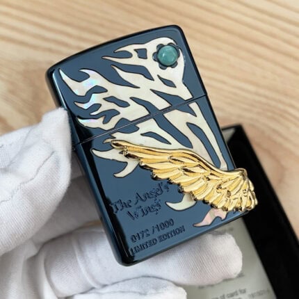 Blue Ice Zippo with gold-tone angel wing, pale graphic and turquoise-colored round accent