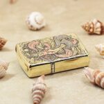 KZ120 engraved brass Zippo Armor lighter laid flat, showing nine-tailed fox and rose-pink accents