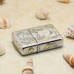 KZ129 engraved Zippo Armor lighter laid flat, showing side skull and ornamental details