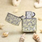 Open numbered arabesque Zippo Armor lighter showing front plaque and lid engraving
