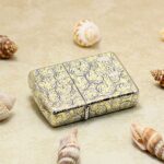 Full-wrap arabesque engraved Zippo Armor lighter lying flat