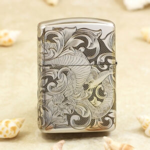KZ143-01 Silver lighter with an intricate dragon and swirling floral engravings on the front, shell-colored background nearby.