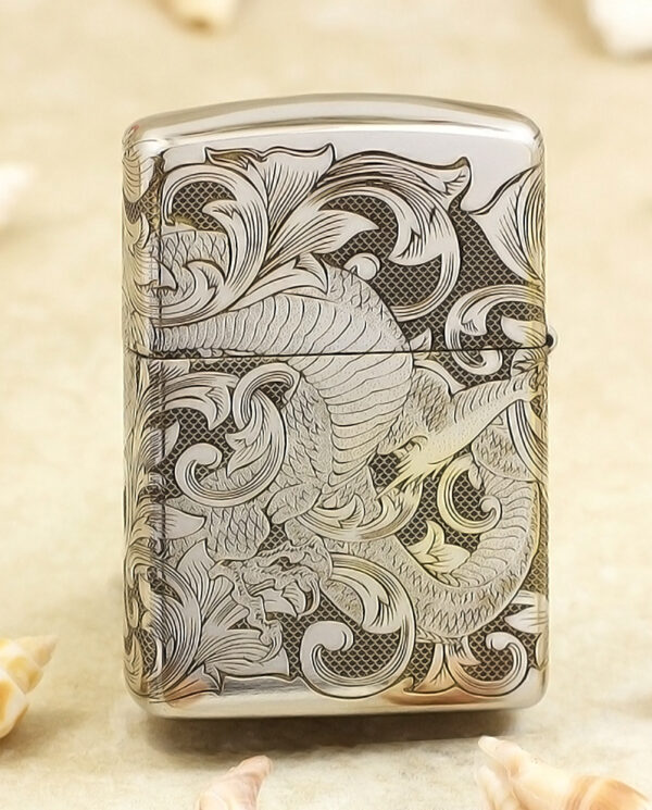 KZ143-01 Silver lighter with an intricate dragon and swirling floral engravings on the front, shell-colored background nearby.