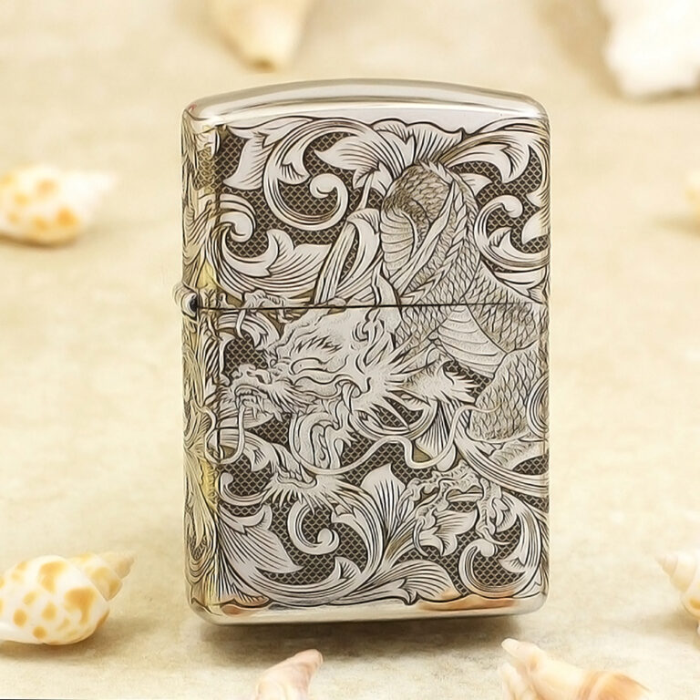 Silver lighter with an intricate black-and-white dragon and scrollwork engraving on its surface